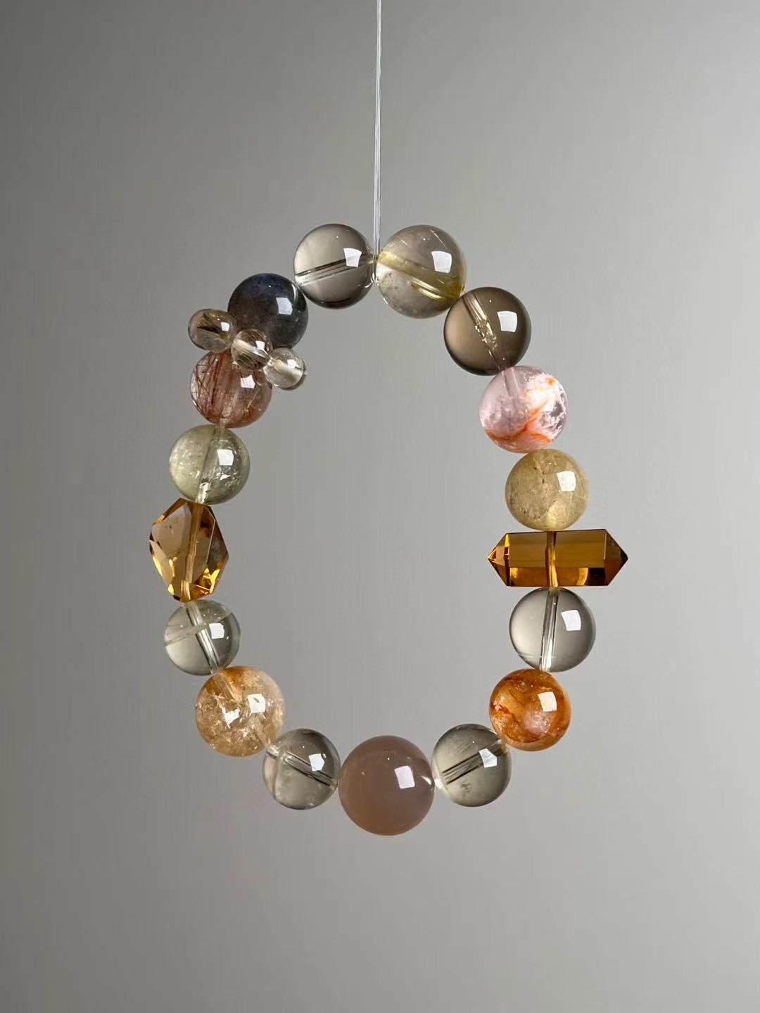 Detail of the Zambian citrine double-terminated point framed by golden rutile, citrine and the runner cluster.