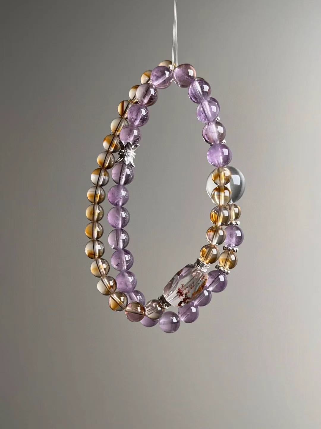 Side angle — paired wraps; Amethyst and Citrine with faceted Phantom Quartz barrel focal and Clear Quartz accents.