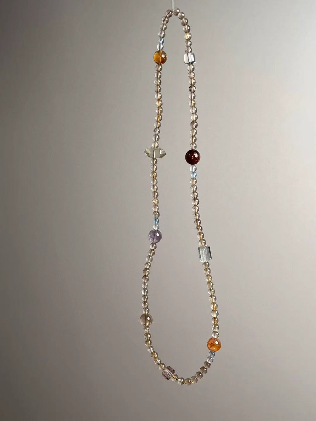 Detail — Citrine tower bead, koi blossom bead and rutilated cube accents in the energy matrix