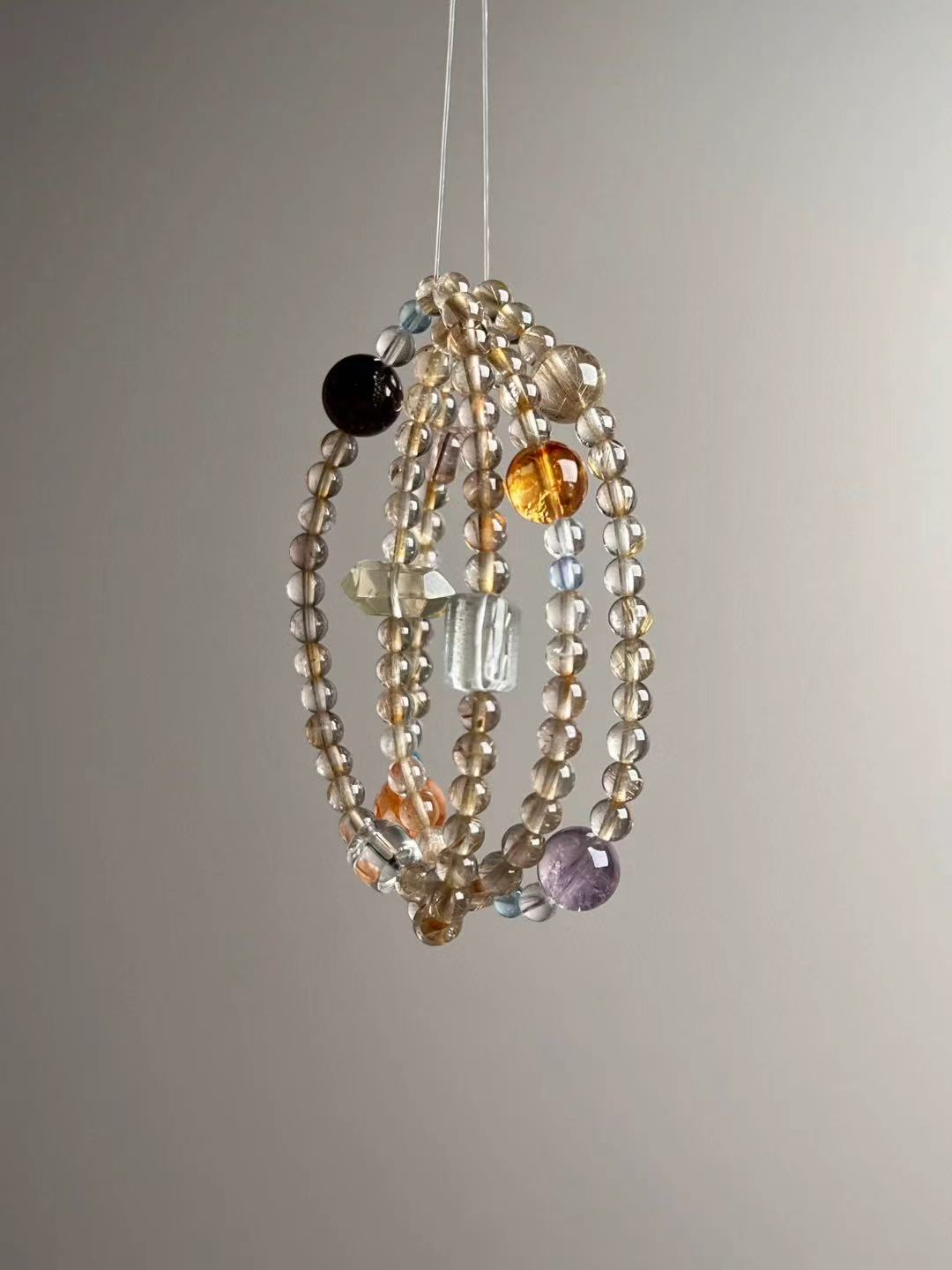 Full layout — slim 3-wrap strand featuring Golden Rutile, Clear Quartz, Green Phantom, Aquamarine and Super Seven.