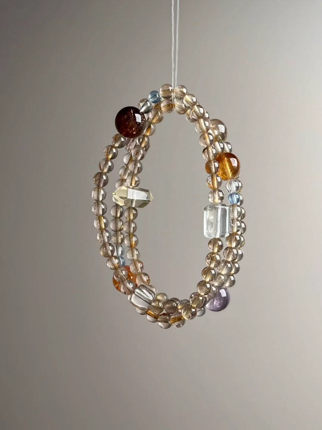 Flat lay — component callouts: Golden Rutile, Clear Quartz, Citrine towers, Aquamarine, Amethyst, Koi blossom, Green Phantom, Super Seven