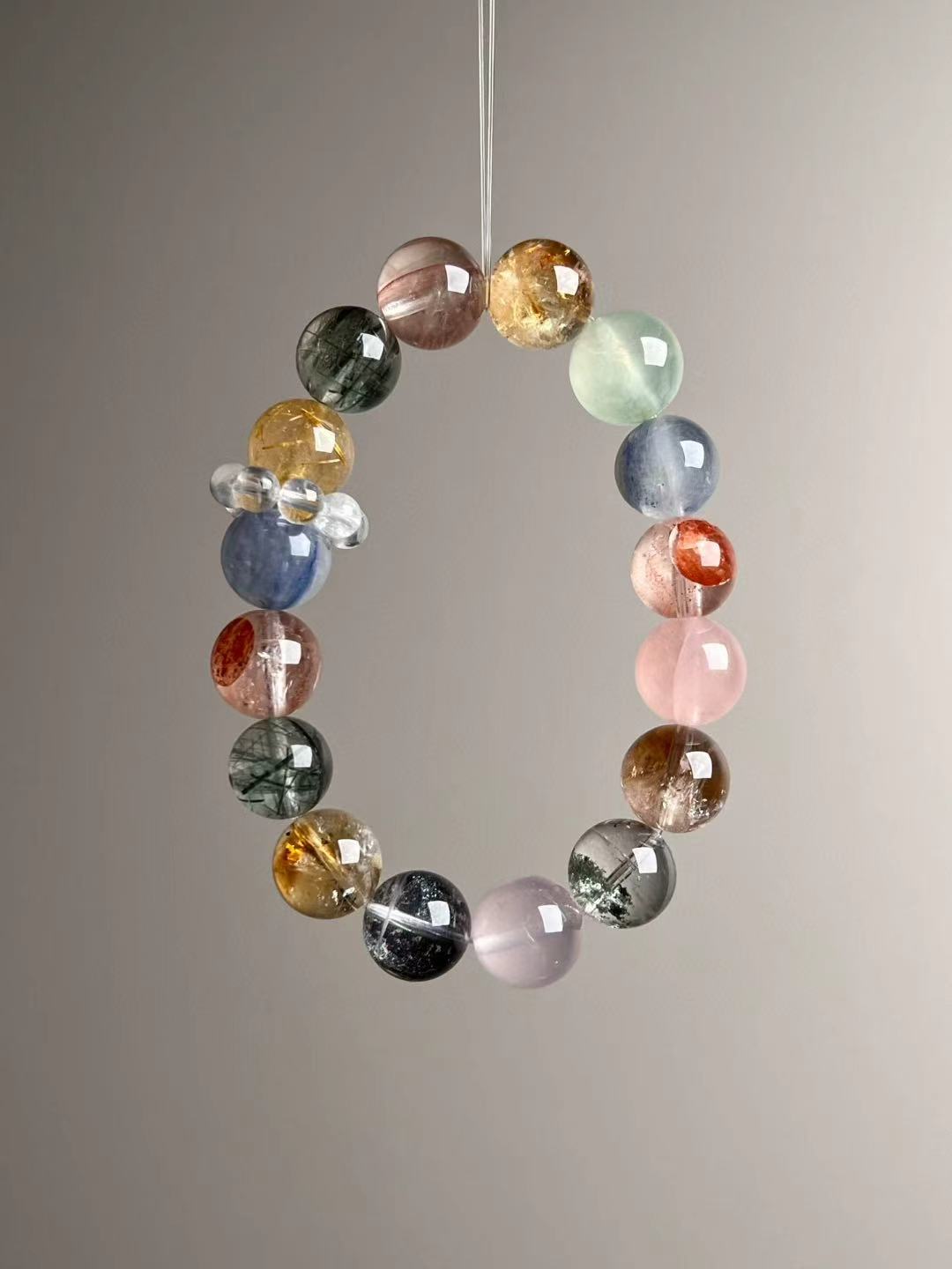 Angle view — mix of Golden Rutilated Quartz, Green Phantom Quartz, Prehnite, Kyanite and Rose Quartz with clear quartz spacers.