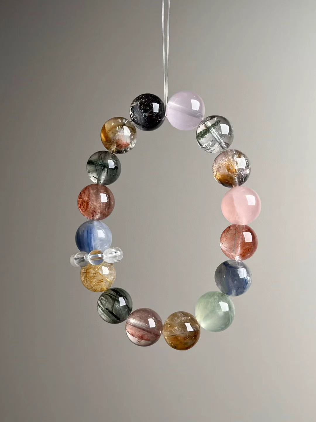 Full circle layout — Starry Goldsand bead, Rose Quartz, Green Phantom Quartz, Golden Rutile, Prehnite and Kyanite arranged around the strand.