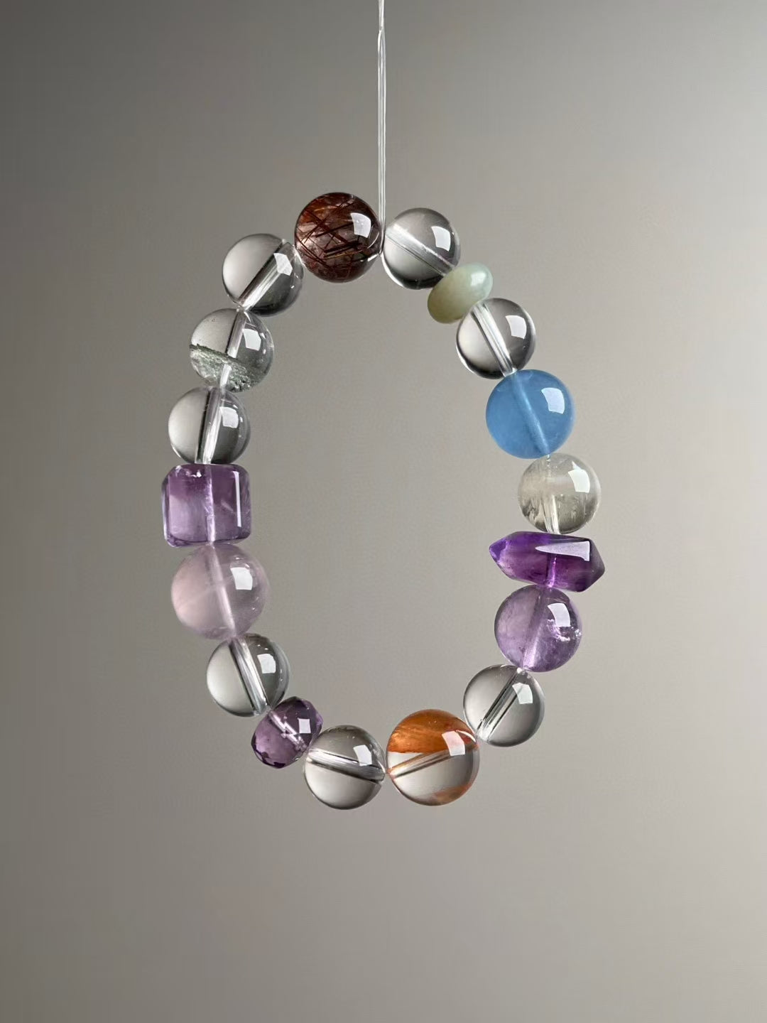 Angle view — Amethyst DT plus Citrine, Clear Quartz and Copper Rutile; Green Phantom & Rose Quartz accents.