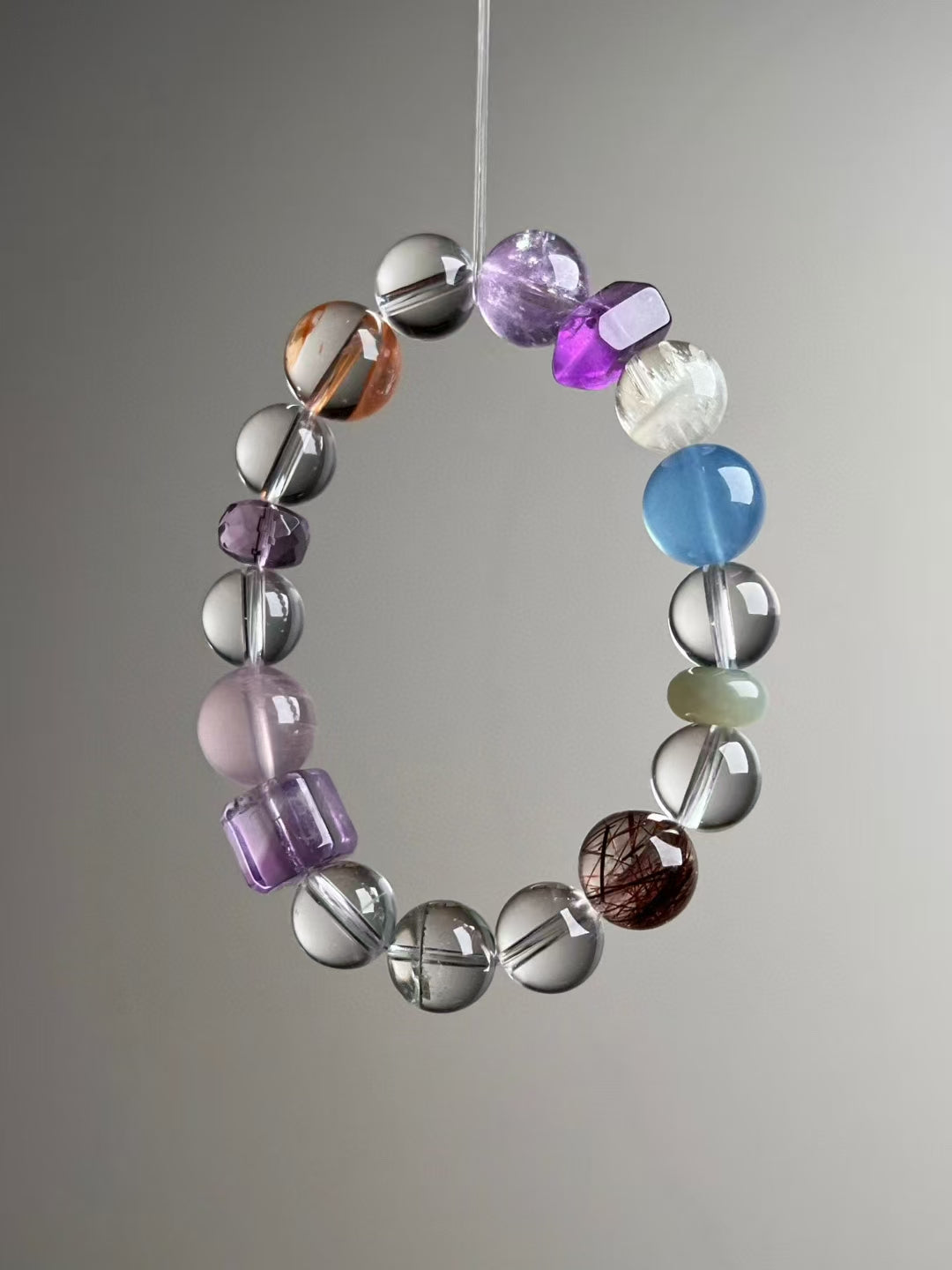 Close detail — purple cube and Rose Quartz with Clear Quartz; Copper Rutile & Green Phantom rounds