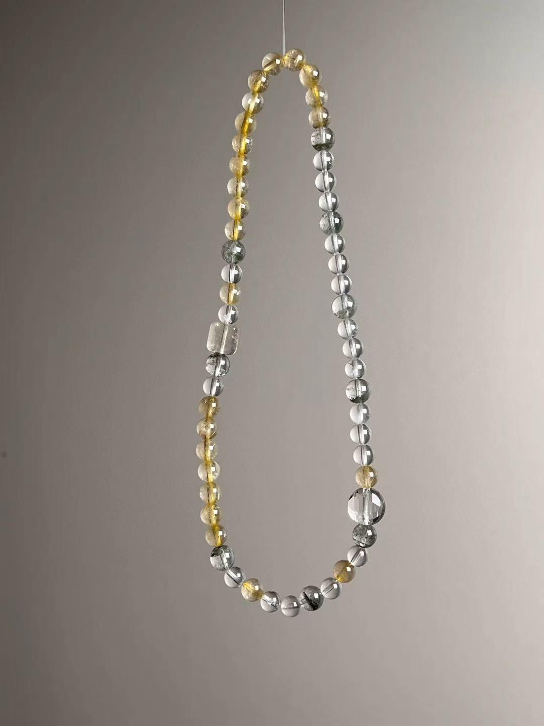 Full layout — single long strand showing mix of Golden Rutile, Clear Quartz and Green Phantom.