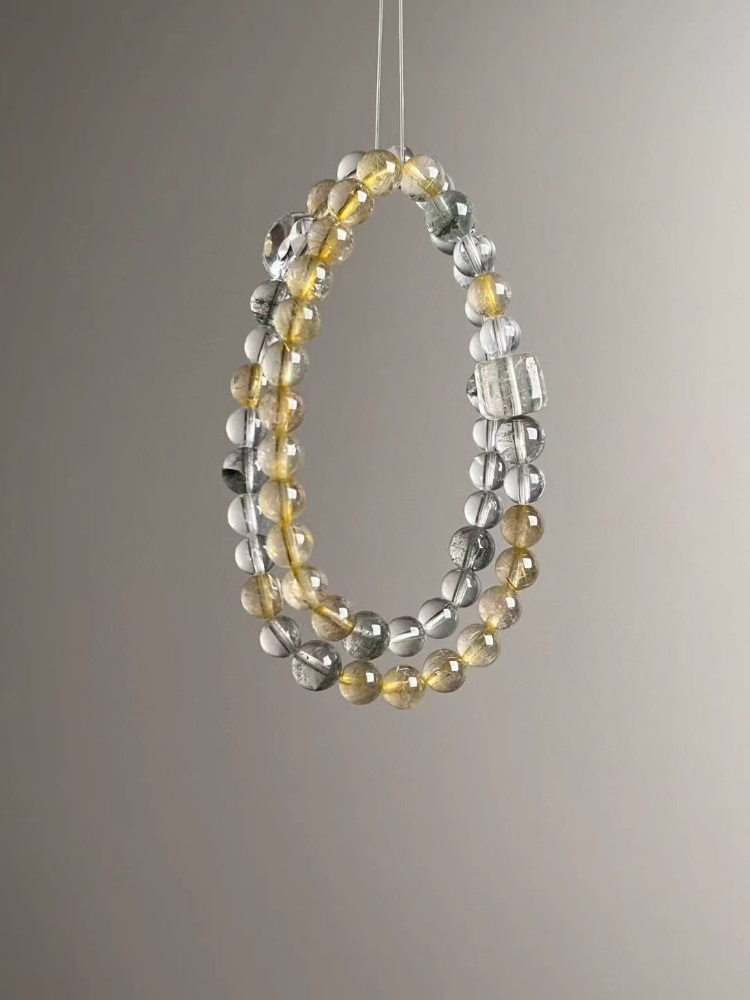 Flat lay — color and texture mix of Golden Rutile Quartz, Clear Quartz and Green Phantom (collage)