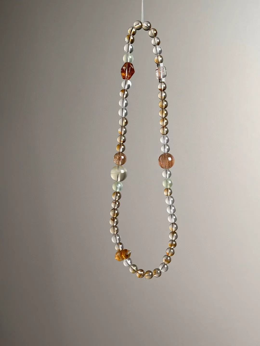 Detail — Citrine double-terminated point, rutilated quartz cube and koi-blossom style spacer in the wealth matrix stack.