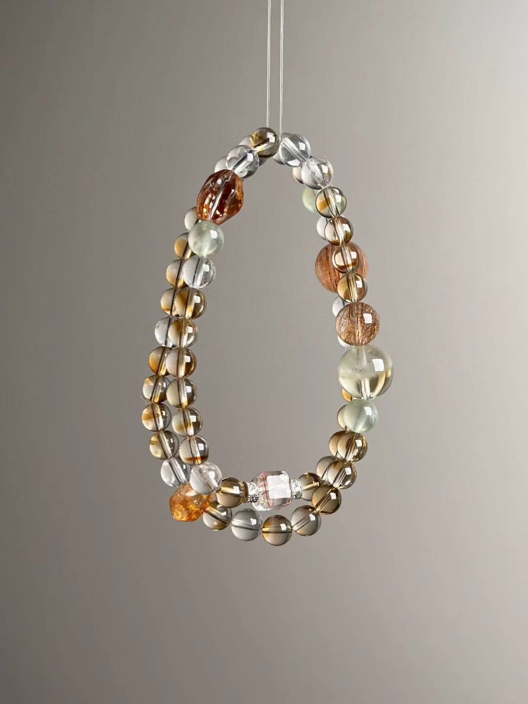 Full layout — long strand showing distribution of Clear Quartz, Citrine tower, Prehnite and Orange Phantom beads.