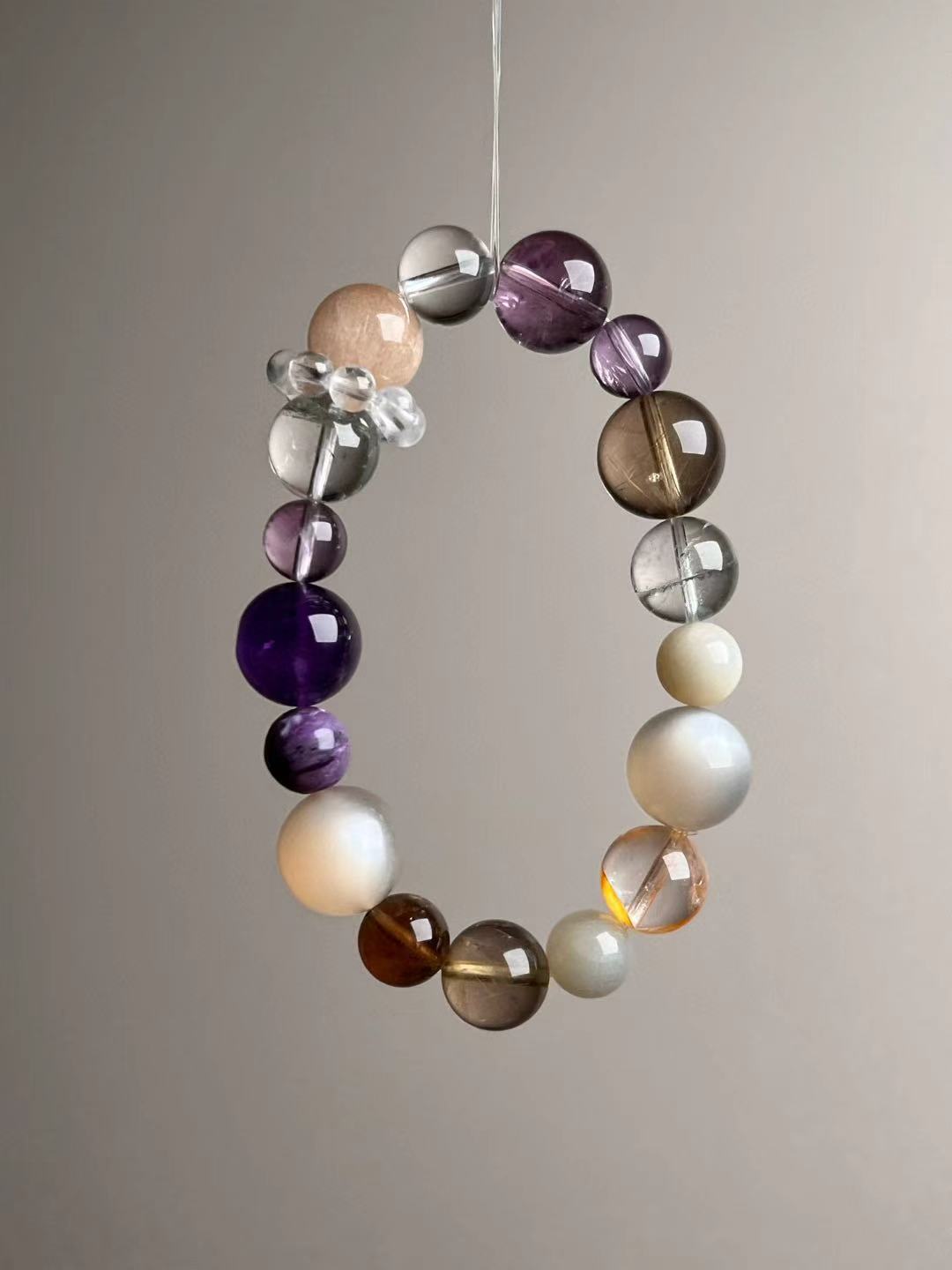 Detail—Clear Quartz bead-cluster spacer next to Orange Moonstone and Auralite-23 beads