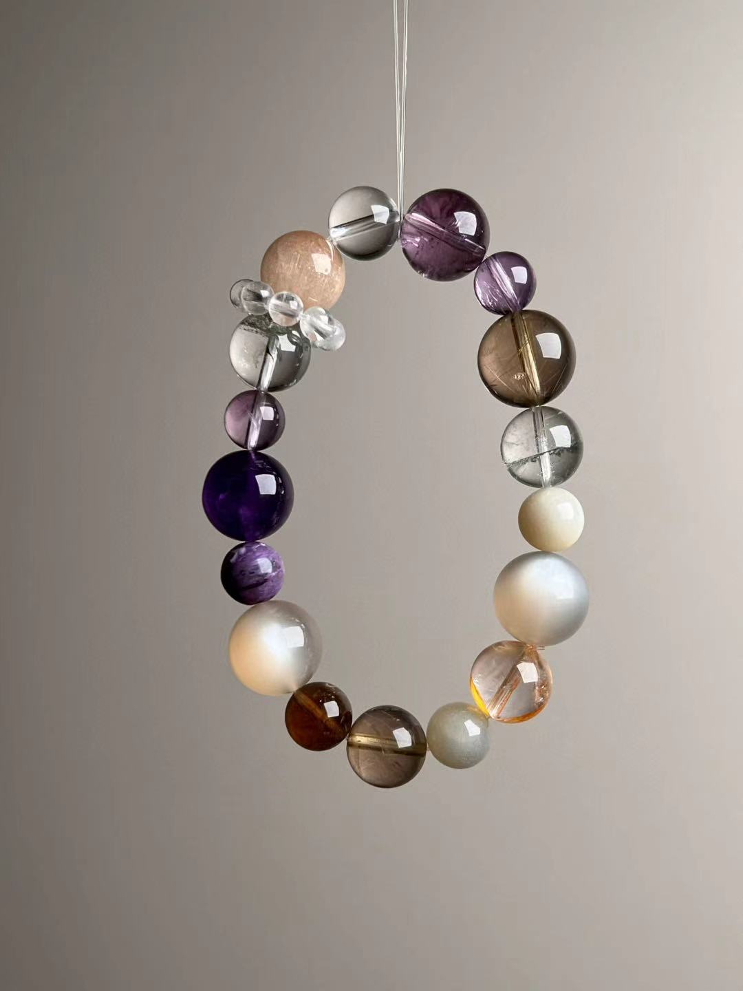 Front hero—Aurora Abundance Matrix bracelet showing Orange Moonstone glow, Auralite-23 purples and golden rutile needles, 14.5–9 mm.