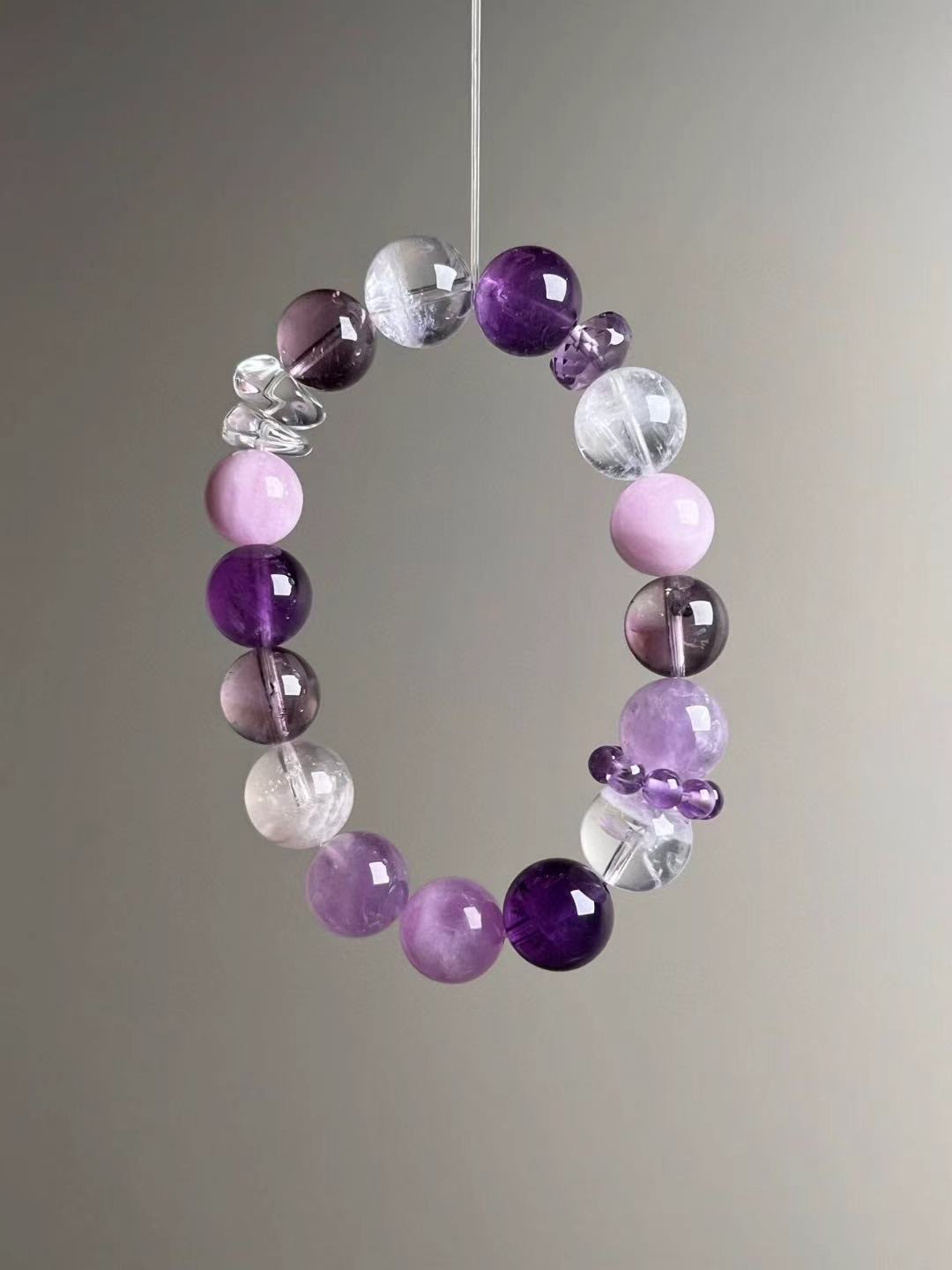 Angled hero—balanced purples and clear tones; textured Clear Quartz spacer and Lepidolite accents