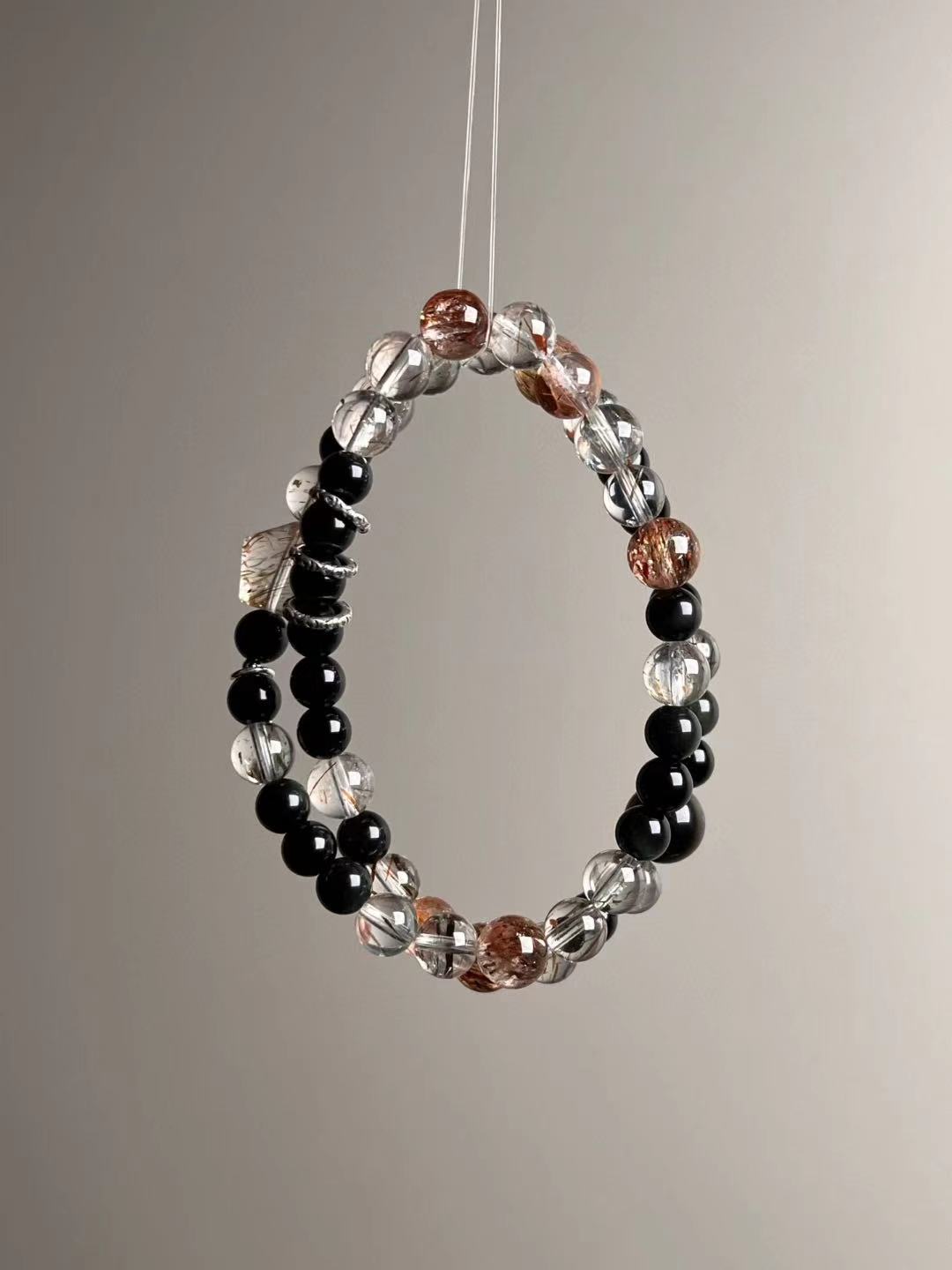Full-length strand layout of the double-wrap with evenly spaced obsidian and black-gold Super Seven beads.