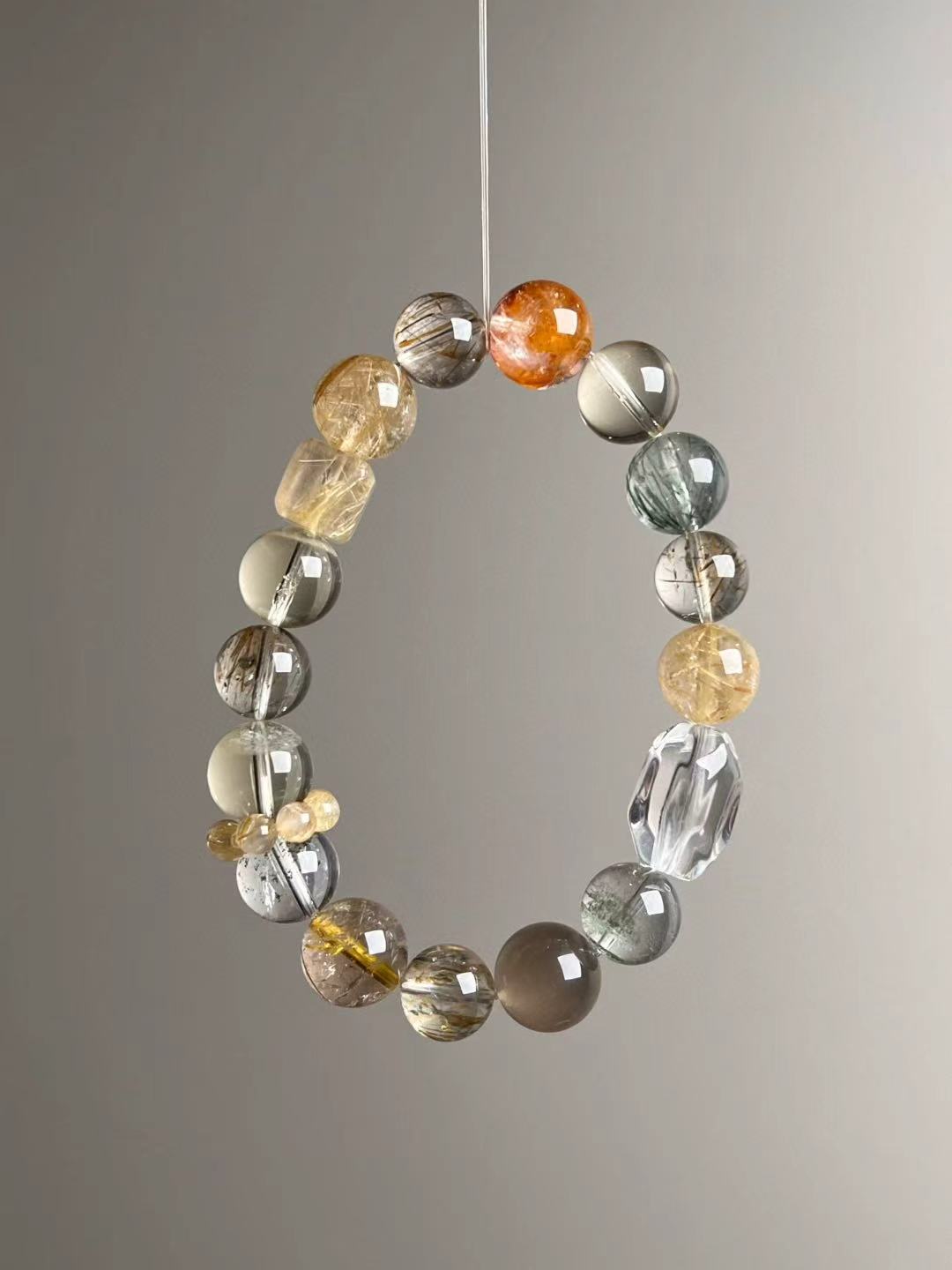 Second angled view—mixed gold, grey and green hues with Clear Quartz ripple bead and yellow cluster spacer