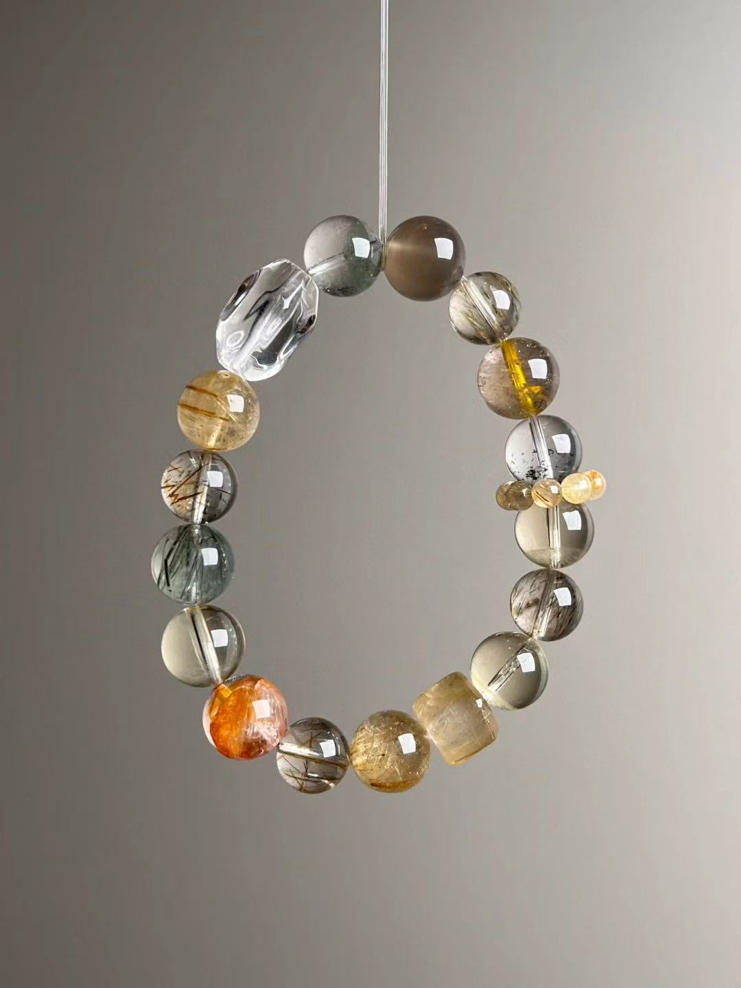 Macro texture—polished Gold Rutilated Quartz, Black-Gold Super Seven, Green Phantom and Clear Quartz beads, 12–10.5 mm
