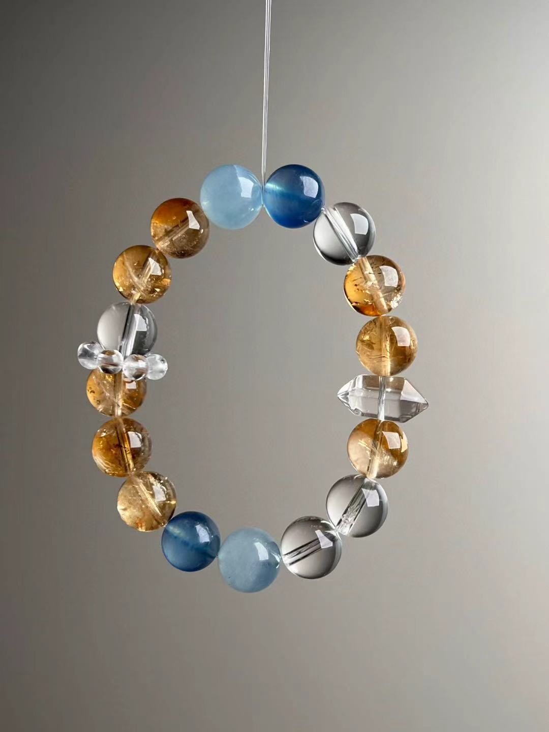 Design detail—clear quartz bead cluster spacer on Aquamarine, Yellow Azeztulite and Clear Quartz 12 mm bracelet