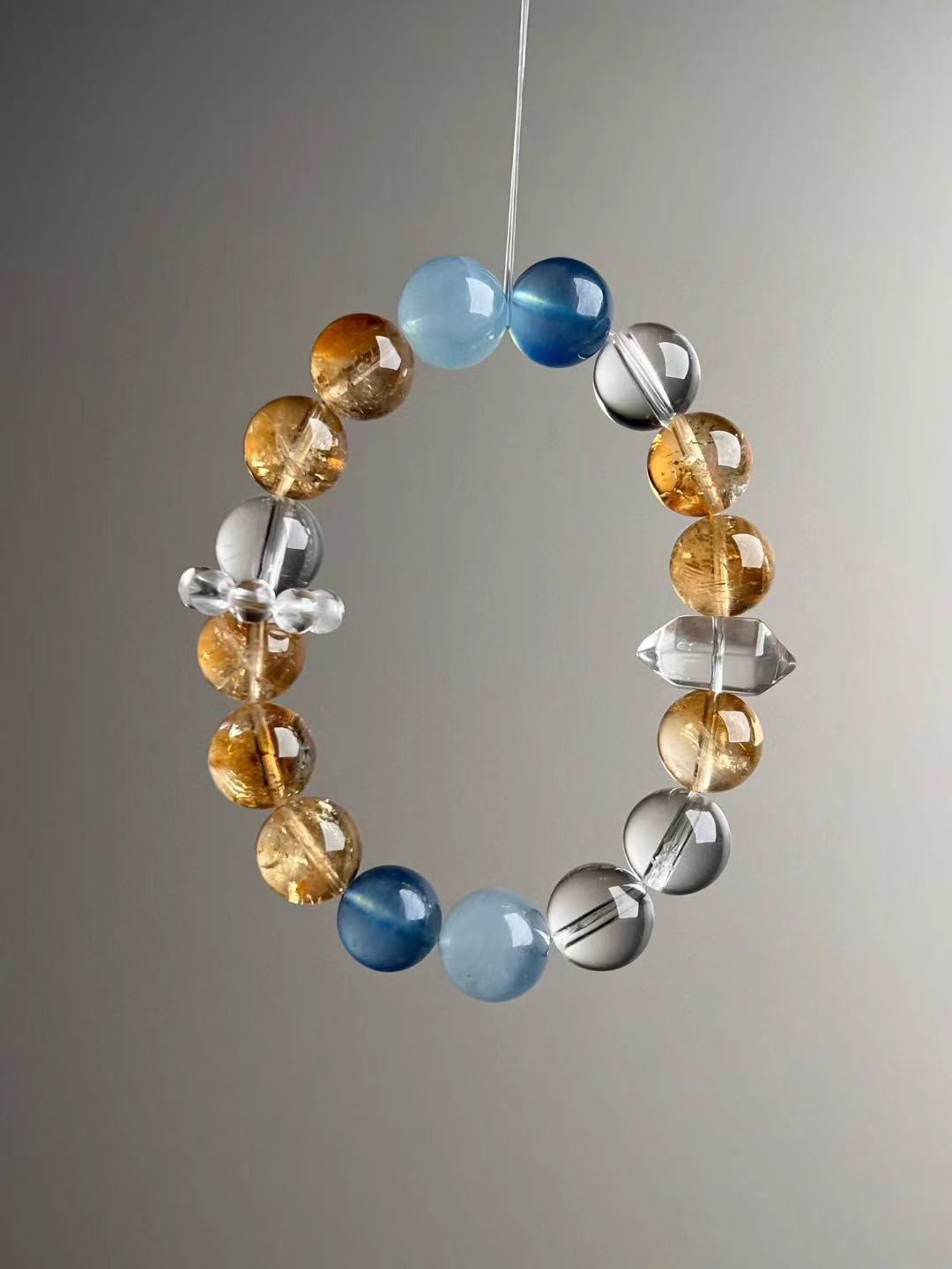 Detail—double-terminated clear quartz point bead with surrounding Yellow Azeztulite and clear quartz beads, 12 mm bracelet.
