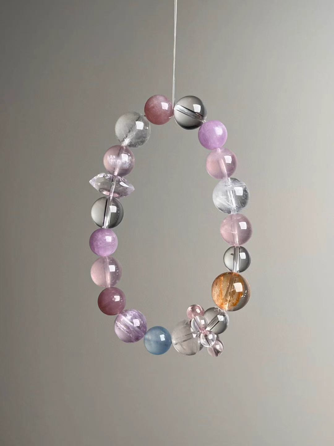 Detail—double-terminated rose quartz point bead and bead-cluster spacer on the Holo Love Matrix bracelet