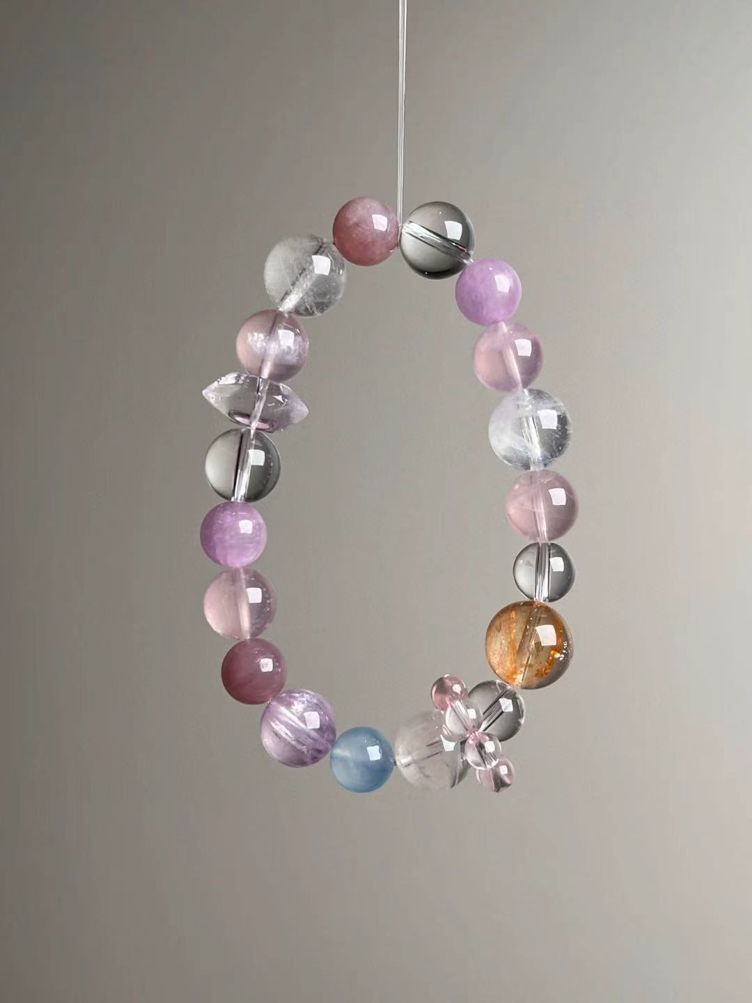 Front hero—Holo Love Matrix bracelet featuring rose quartz double-terminated bead, lepidolite and mixed clear quartz, 13–9 mm.