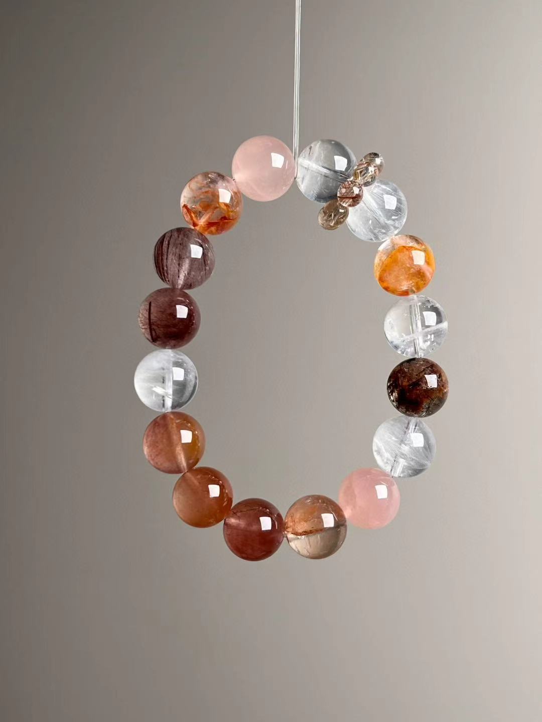 Detail—multicolor rutile bead-cluster runner next to clear quartz and rose quartz beads