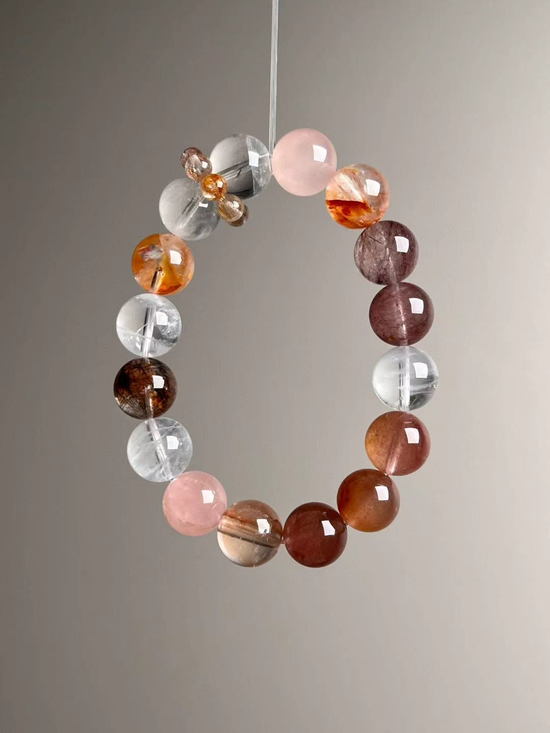 Angled hero view—mix of White Phantom Quartz, Golden Garden Quartz, red copper rutilated quartz and strand runner detail