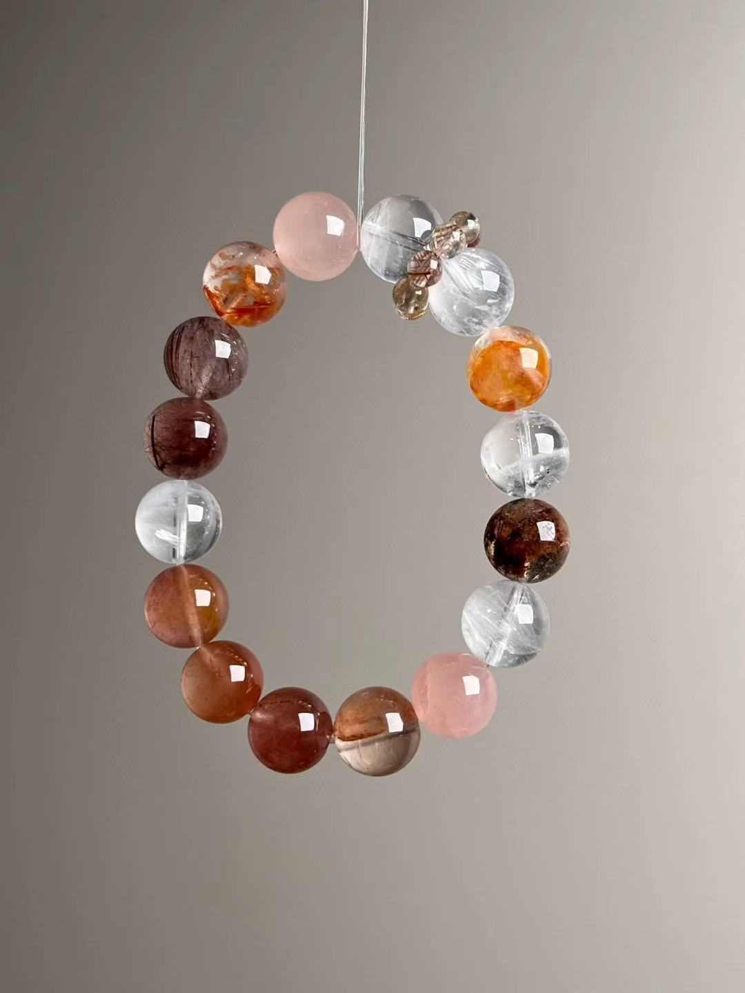 Second angled view—12 mm beads with smoky hair quartz, Rose Quartz, and clear quartz separators