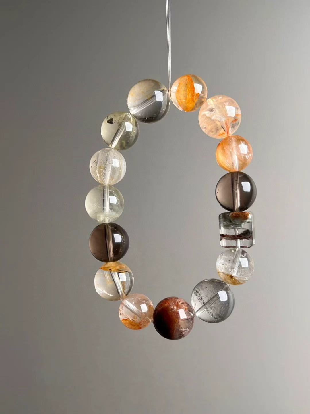 Front hero—Quantum Wealth Resonance bracelet showing Smoky Quartz, red/green phantoms and a square rainbow phantom cube bead