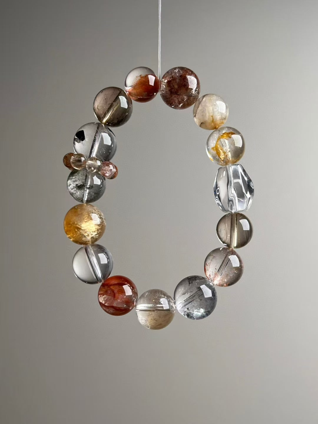Hero angle B: Rainbow Flash Quartz and Green Phantom detail within the wealth-protection matrix bracelet.