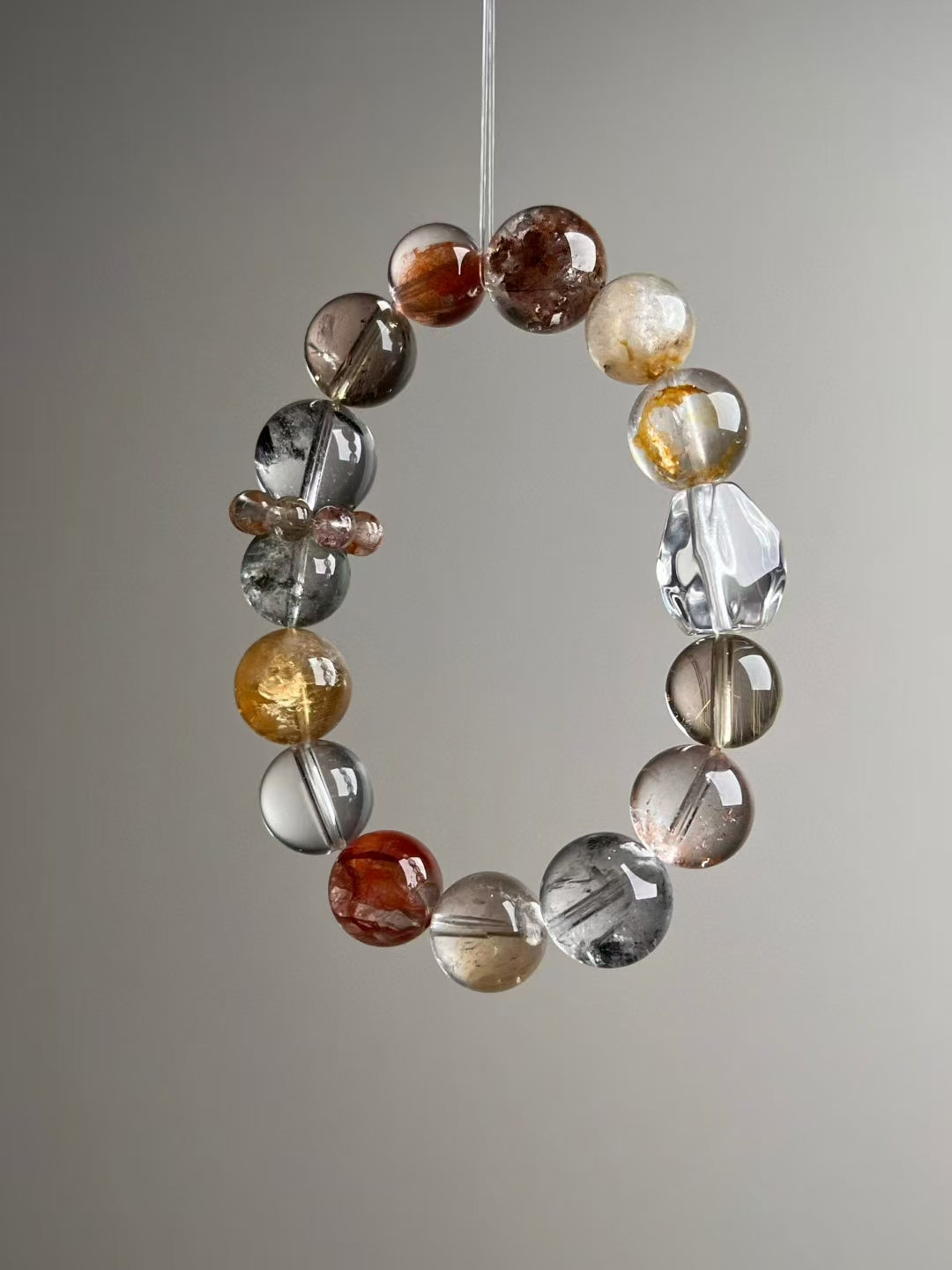 Hero angle C: Citrine tower bead and rutile phantom quartz detail on high-frequency bracelet