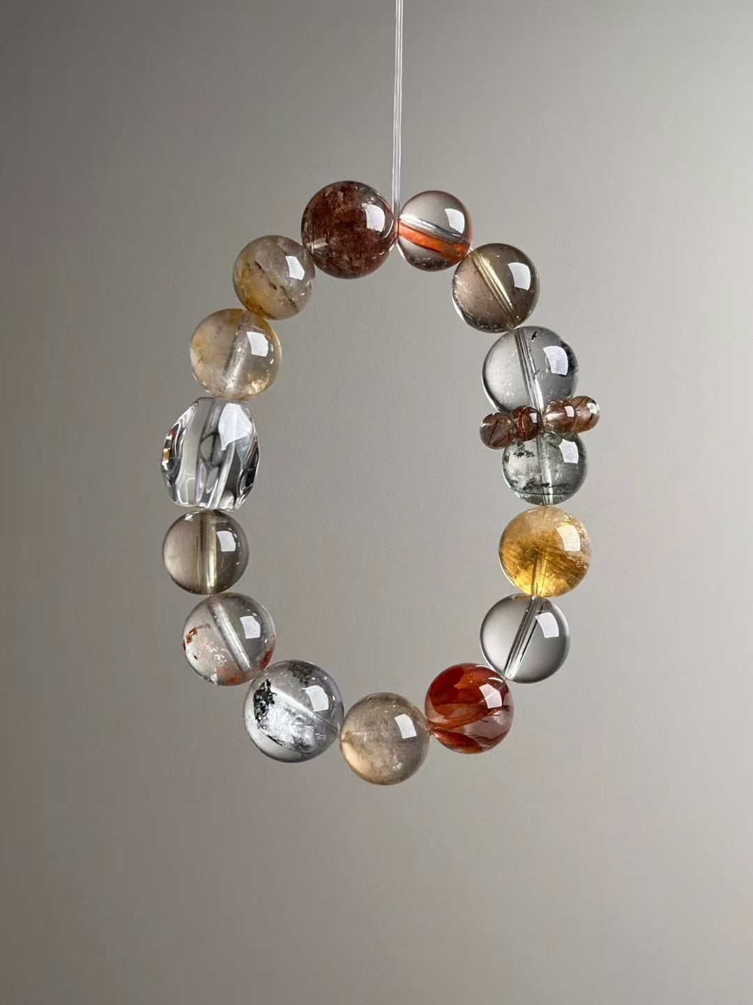 Hero angle E: Mixed phantom inclusions and golden rutile needles — close detail.
