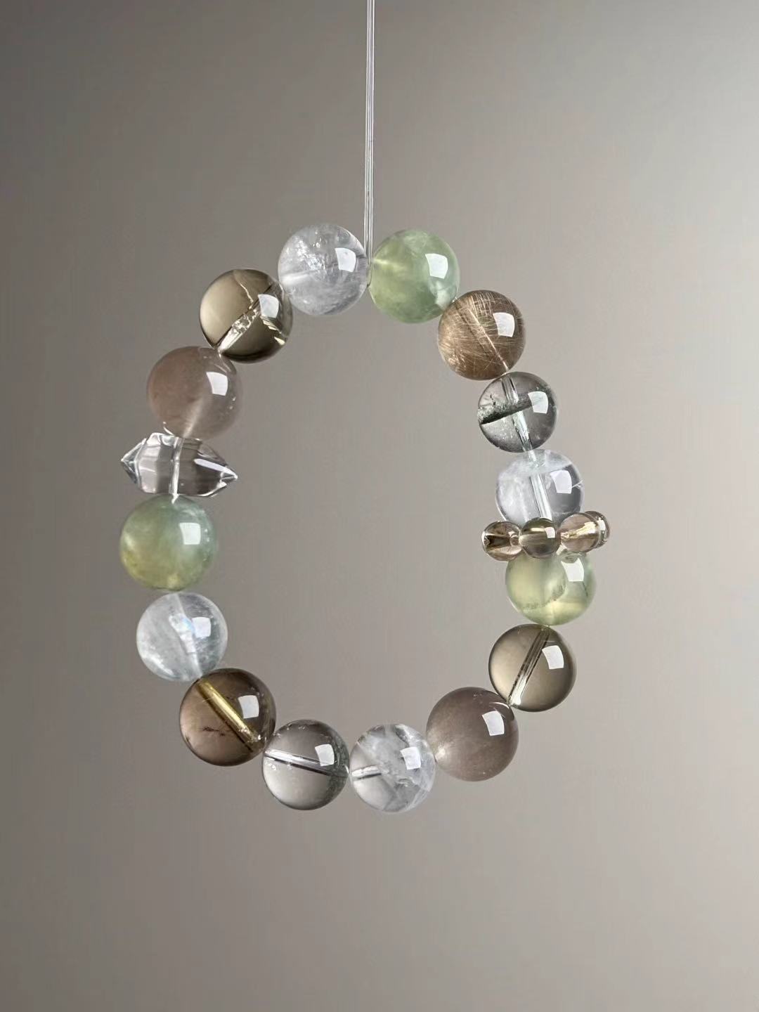 Wealth Matrix bracelet showing White & Green Phantom Quartz accents — hero angle B.