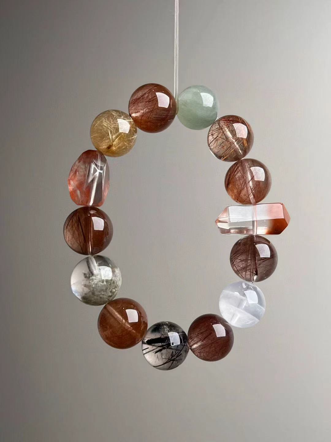 Copper rutile quartz bracelet with mixed hair and phantom quartz beads — floating ring view