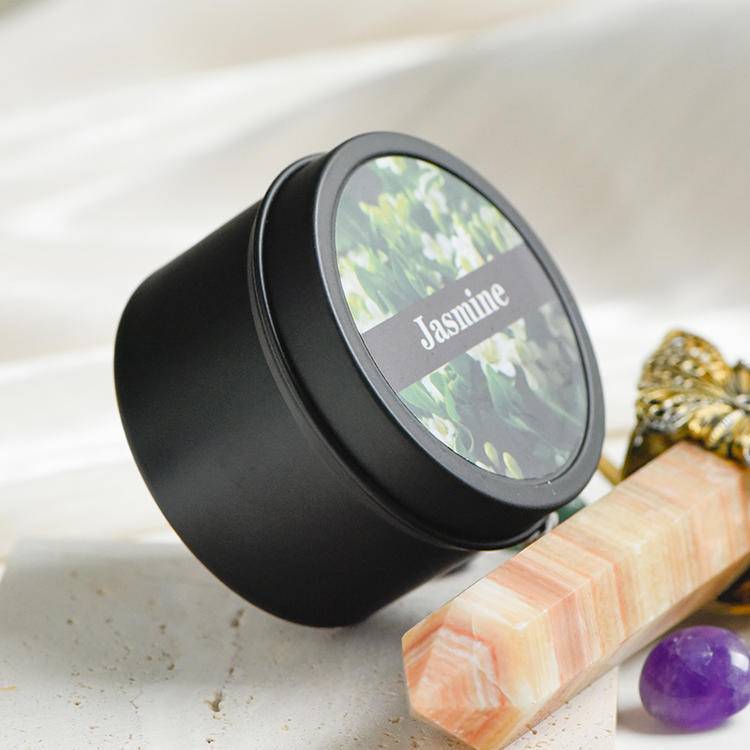 Closed black travel tin candle labeled Jasmine, minimal matte finish.