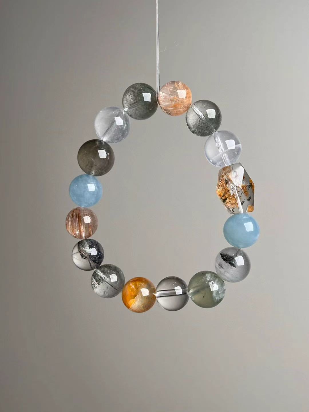 Side view showing double-terminated yellow citrine-style focal and balanced gray–blue–gold palette