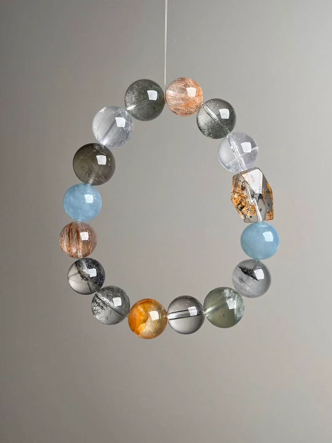 Prosperity Matrix bracelet composition — golden rutilated quartz, citrine family, gray and orange moonstone, copper rutile, garden quartz.