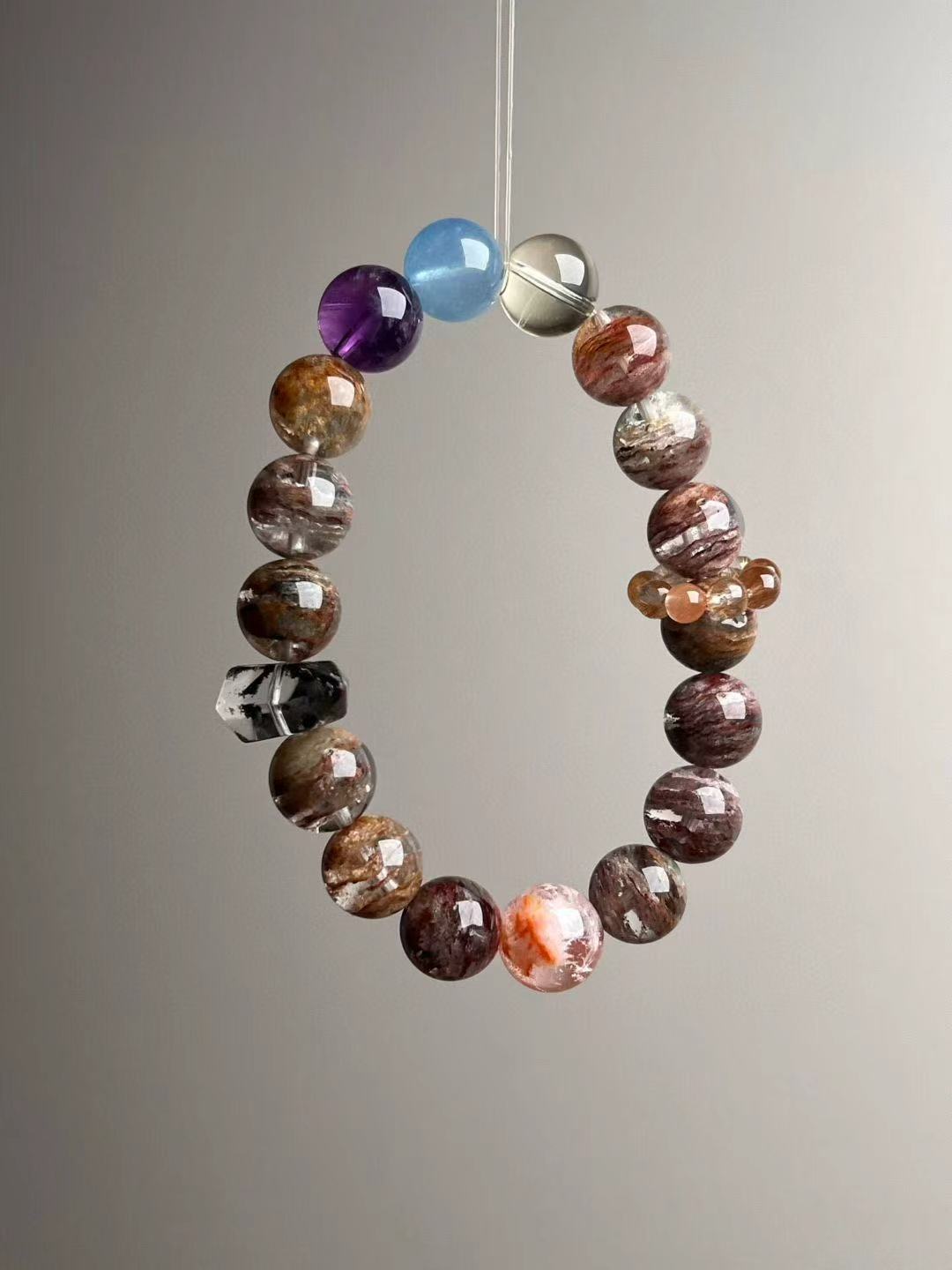 Seven-Spectrum Guardian bracelet flat lay showing orange-snow phantom beads