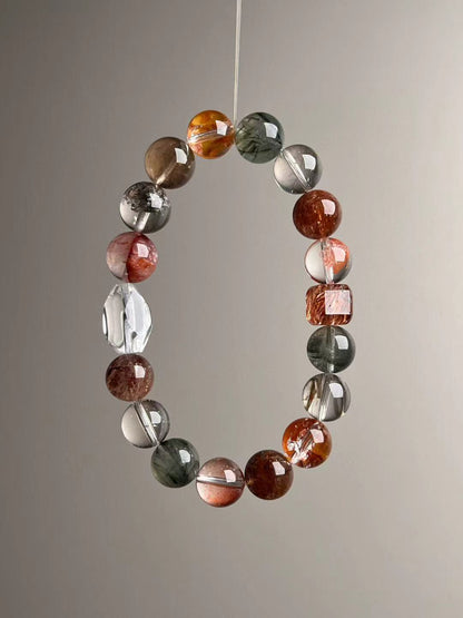 Alternate orientation showing the Auralite-23/ghost-quartz blend and protective black-gold super seven; natural color variation visible.