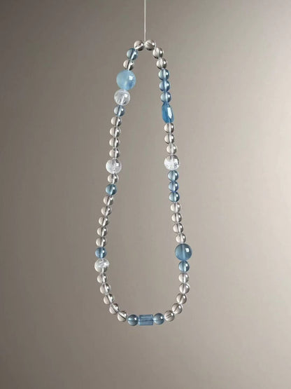Full layout — slim triple-wrap strand featuring aquamarine, clear quartz and white phantom quartz.