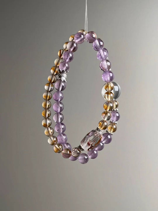 Side angle — paired wraps; Amethyst and Citrine with faceted Phantom Quartz barrel focal and Clear Quartz accents.