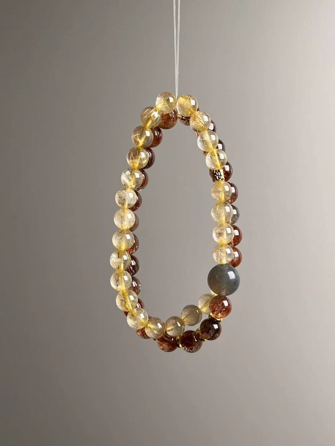 Full layout — two slim strands showing alternating Black-Gold Super Seven and Golden Rutile, elastic stringing, 11–7 mm.