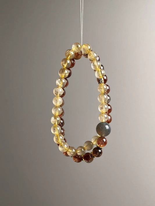 Full layout — two slim strands showing alternating Black-Gold Super Seven and Golden Rutile, elastic stringing, 11–7 mm.