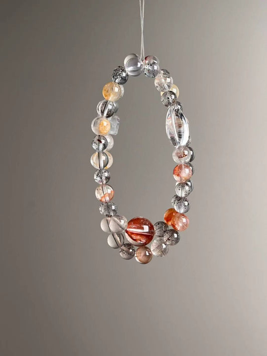 Angle view — mix of Black Strawberry Quartz, Clear Quartz and Garden Quartz with Super Seven feature cube bead.