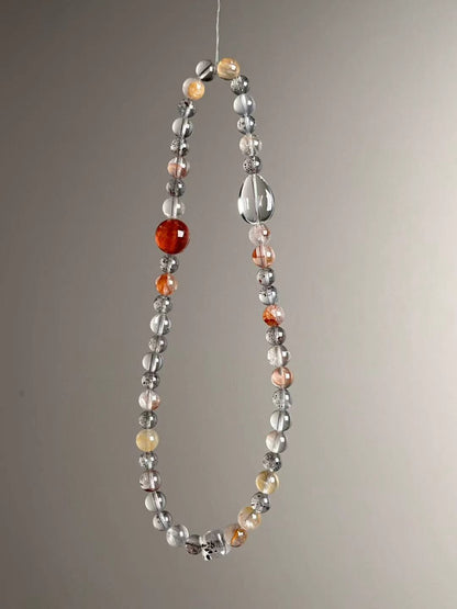 Side angle — fiery red Garden Quartz centerpiece with Clear Quartz and protective Black Strawberry Quartz.