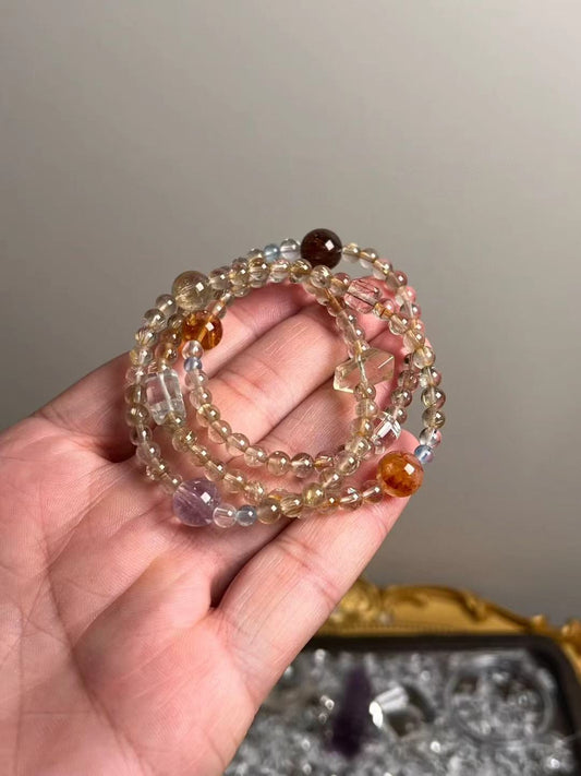 Angle view — mix of fine Golden Rutile, Clear Quartz and Aquamarine with Amethyst accent bead