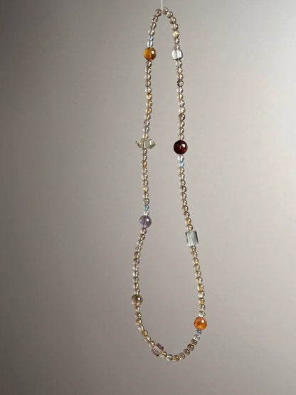 Detail — Citrine tower bead, koi blossom bead and rutilated cube accents in the energy matrix
