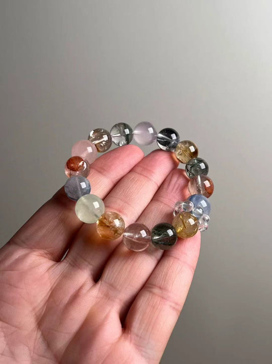 Hero view — multi-gem bracelet with Starry Goldsand (blue goldstone), Rose Quartz, Green Phantom Quartz, Golden Rutilated Quartz, Kyanite, Prehnite and Clear Quartz halo spacers, approx 12.5 mm beads.