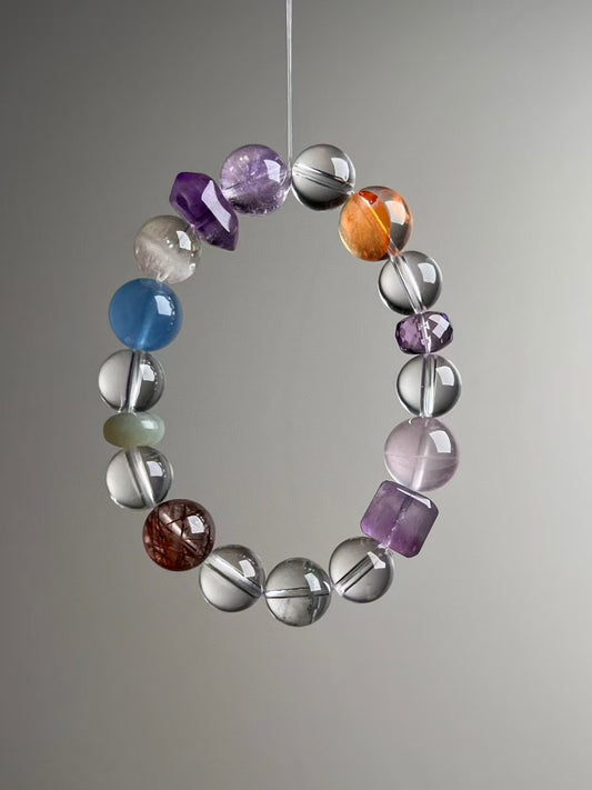 Side angle — orange Citrine focal beside Clear Quartz and Amethyst; Aquamarine visible