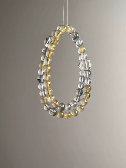 Flat lay — color and texture mix of Golden Rutile Quartz, Clear Quartz and Green Phantom (collage)