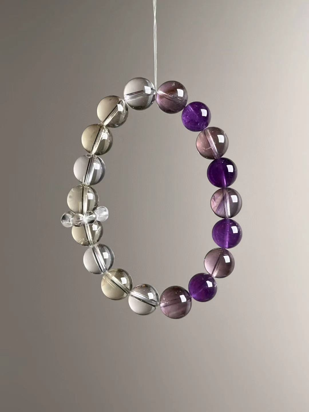 Angle view — gradient section of deep Amethyst transitioning into Clear Quartz and light Citrine.