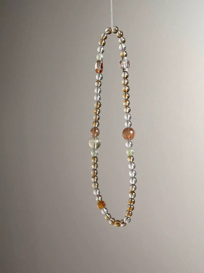 Side angle — close-up on copper rutile accents with Clear Quartz and green Prehnite rounds.